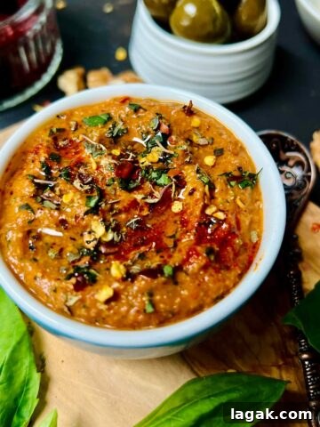 Roasted red bell pepper sauce on a wooden board.