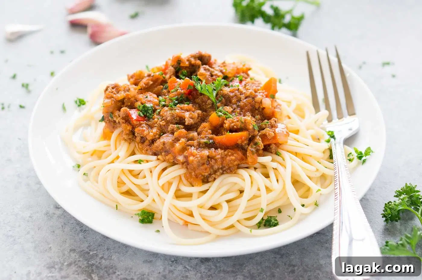 close up image of Bolognese sauce over spaghetti