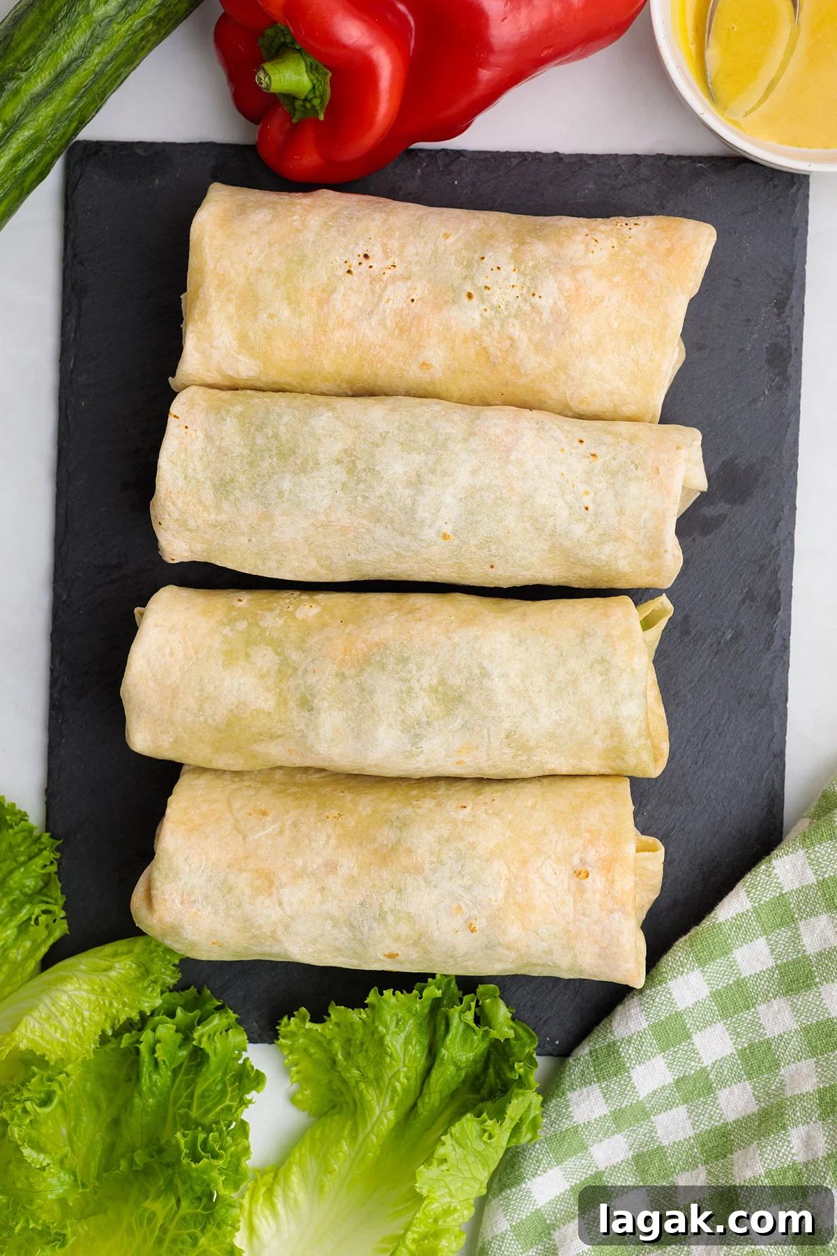 Honey Mustard Chicken Wrap Recipe: Quick Flavorful Lunch Idea 12 Honey Mustard Chicken Wraps rolled up on a cutting board.