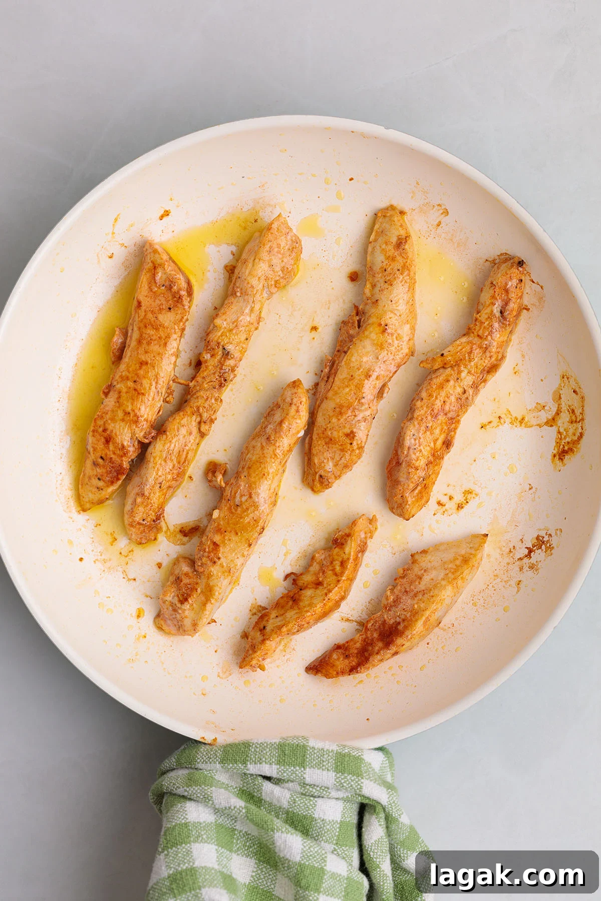 Honey Mustard Chicken Wrap Recipe: Quick Flavorful Lunch Idea 6 Cooked seasoned chicken strips on a plate.