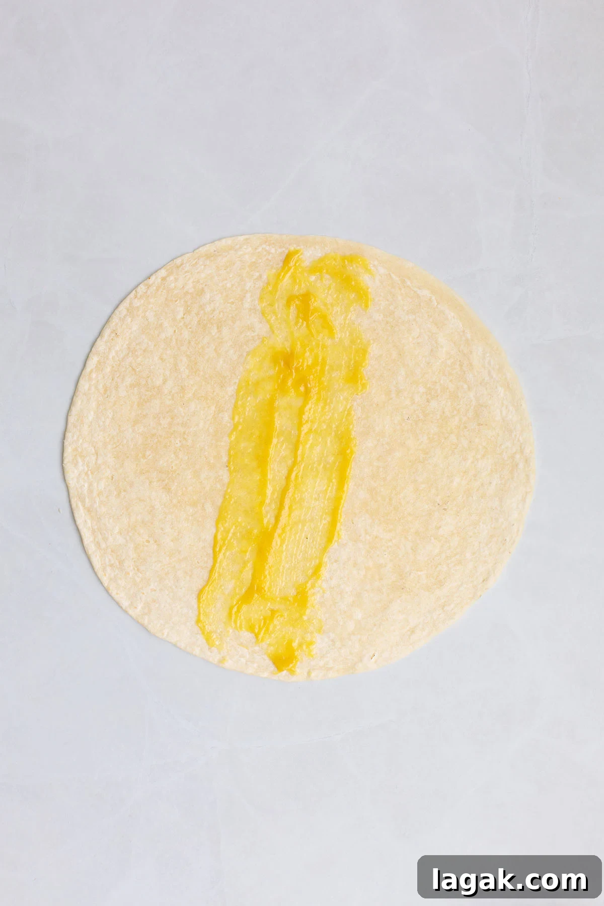 Honey Mustard Chicken Wrap Recipe: Quick Flavorful Lunch Idea 8 Honey mustard sauce spread over a flour tortilla.