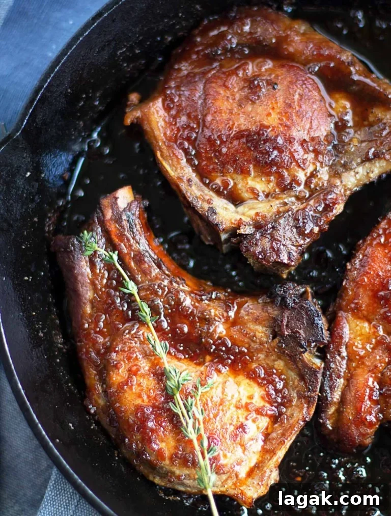 honey glazed pork chops in a skillet.