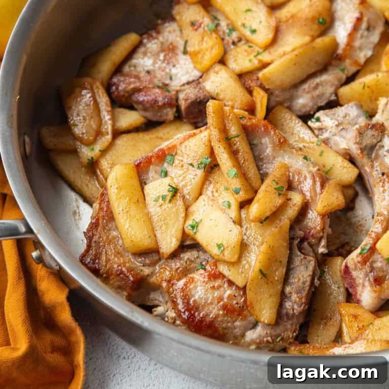 pork chops and apples in a skillet.