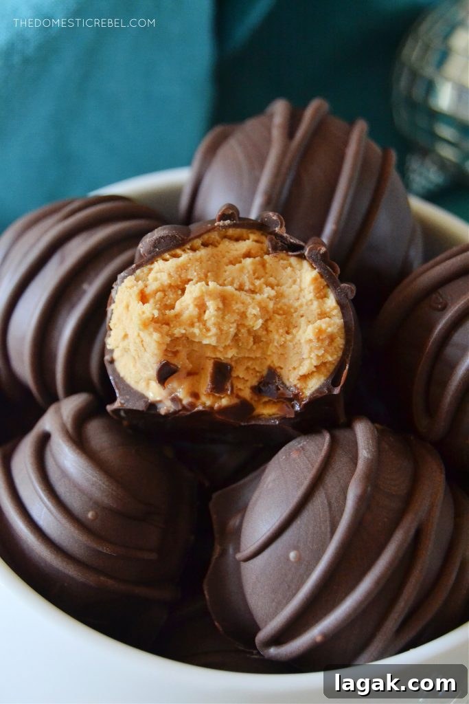 No-Bake Peanut Butter Balls Recipe for Quick Homemade Treats 4 closeup of a bowl full of peanut butter balls. one has a bite missing from it.
