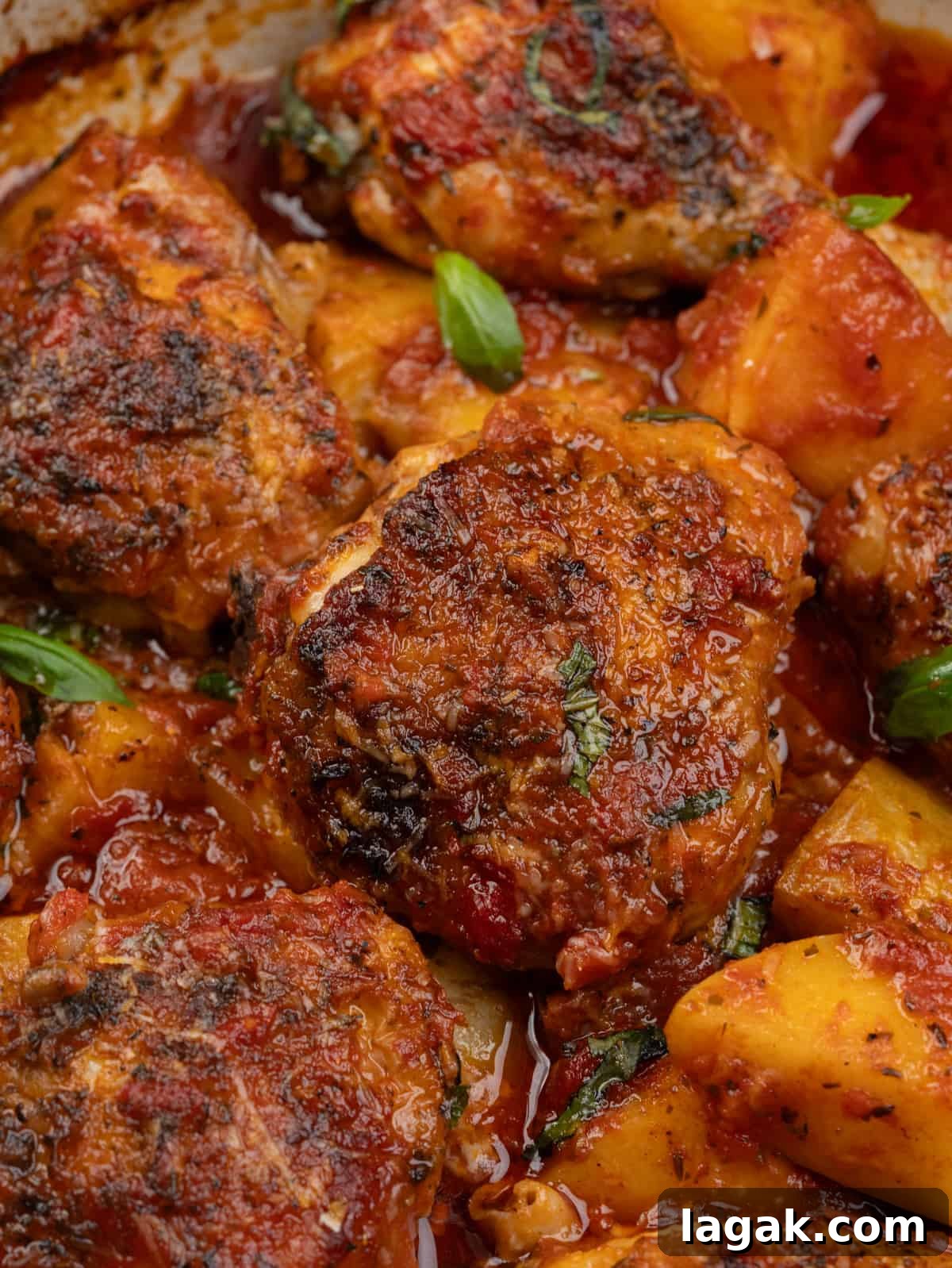 Italian-Style Chicken and Roasted Potatoes Recipe 3 close up of Chicken and potatoes baked in Italian tomato sauce.