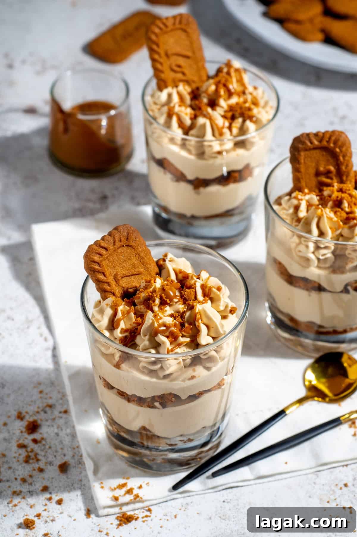 Speculoos (Biscoff) Tiramisu Recipe — Classic with Cookie Butter 2 Three glasses of speculoos tiramisu on a white background.