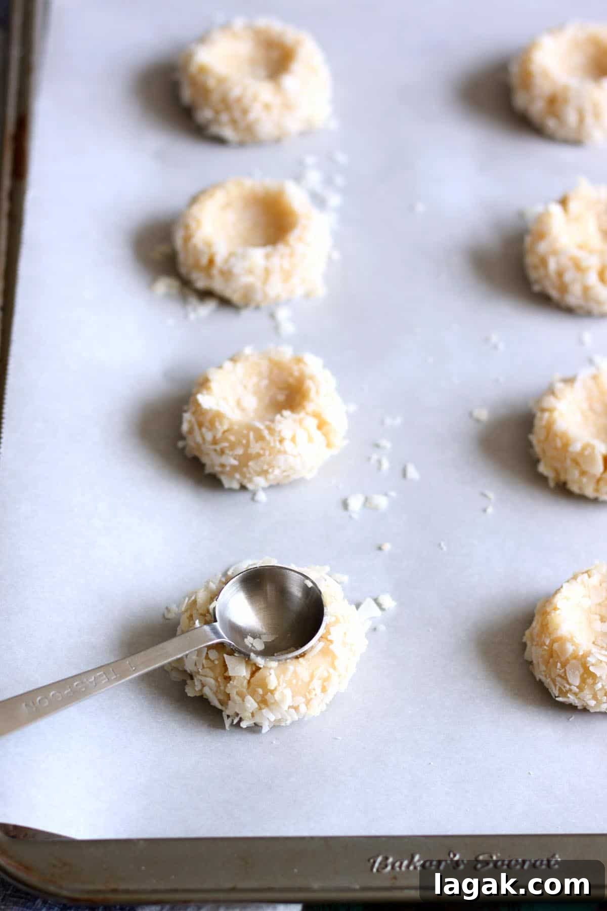 Guava Cookie Recipe: Crispy, Fruity Baked Cookies 6 Making thumbprint indentation on dough balls with a teaspoon.