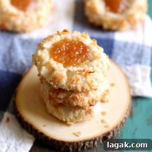 Guava Cookie Recipe: Crispy, Fruity Baked Cookies 9 A stack of coconut guava cookies on a wooden coaster.