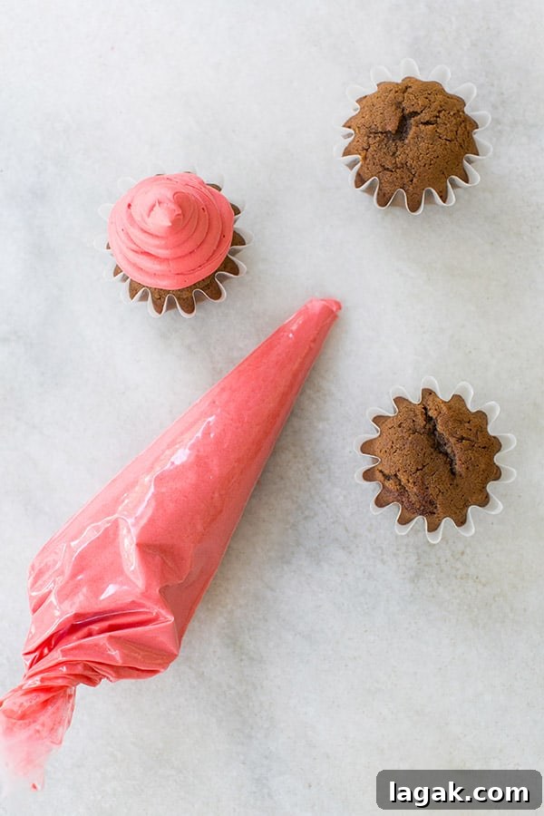 Santa Hat Gingerbread Cupcakes Recipe for Holiday Parties 3 Frosting a santa hat cupcake.
