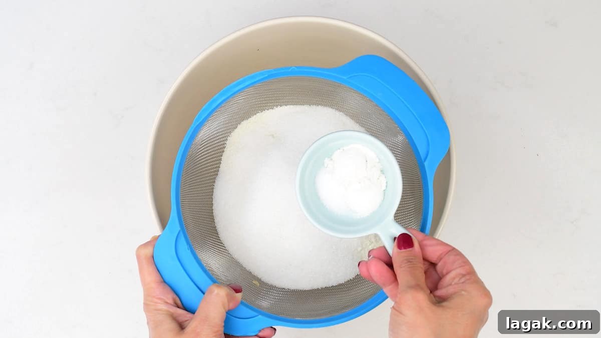 sifting flour and baking powder into a mixing bowl