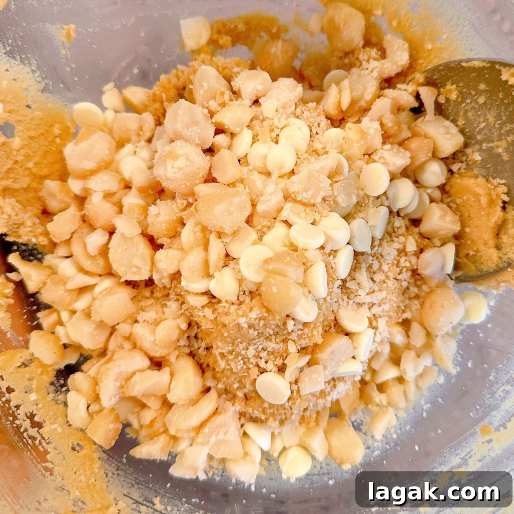White Chocolate Macadamia Pudding Cookies Recipe 7 Adding nuts and baking chips to cookie dough.