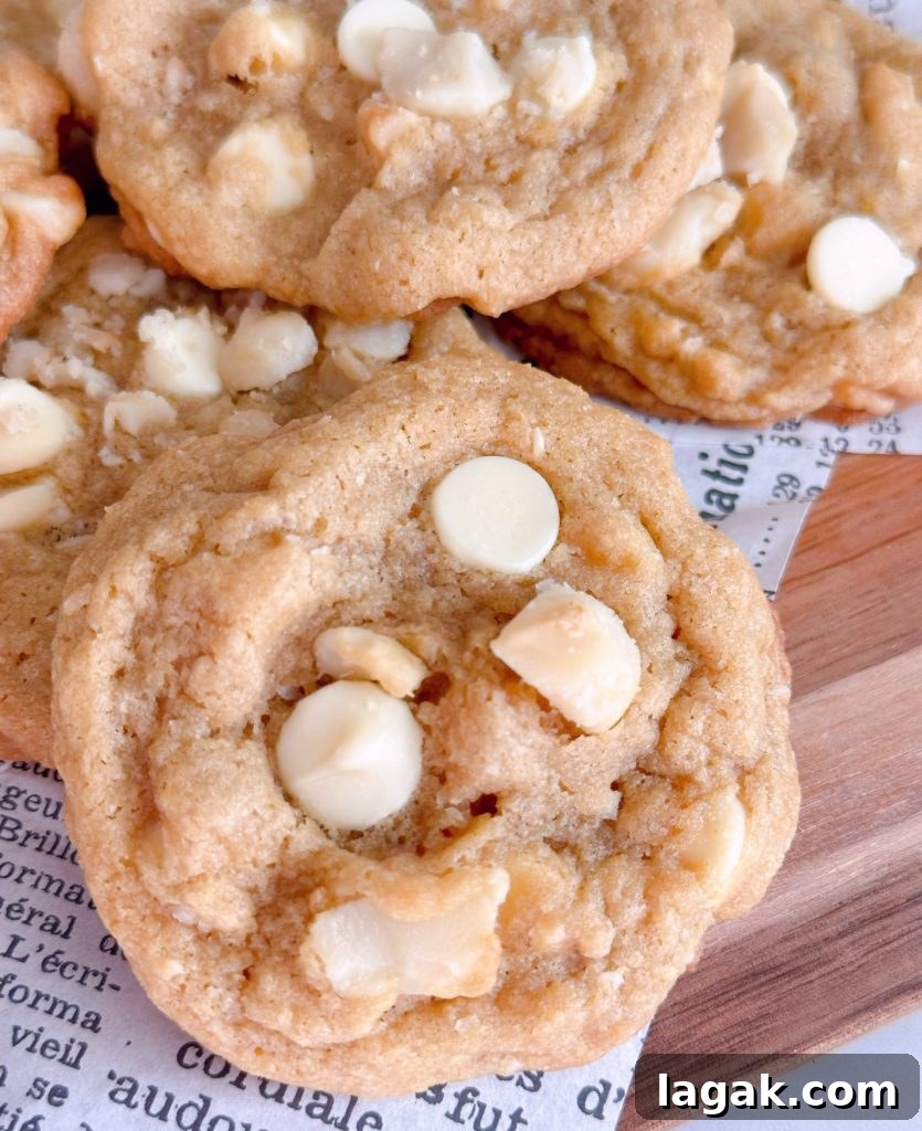 White Chocolate Macadamia Pudding Cookies Recipe 8 Close-up photo of white chocolate chip nut cookies.