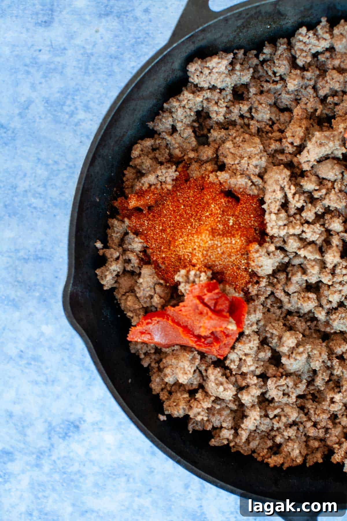 Authentic Ground Beef Tacos Recipe for Weeknight Dinners 5 A skillet filled with ground beef and spices and tomato paste.
