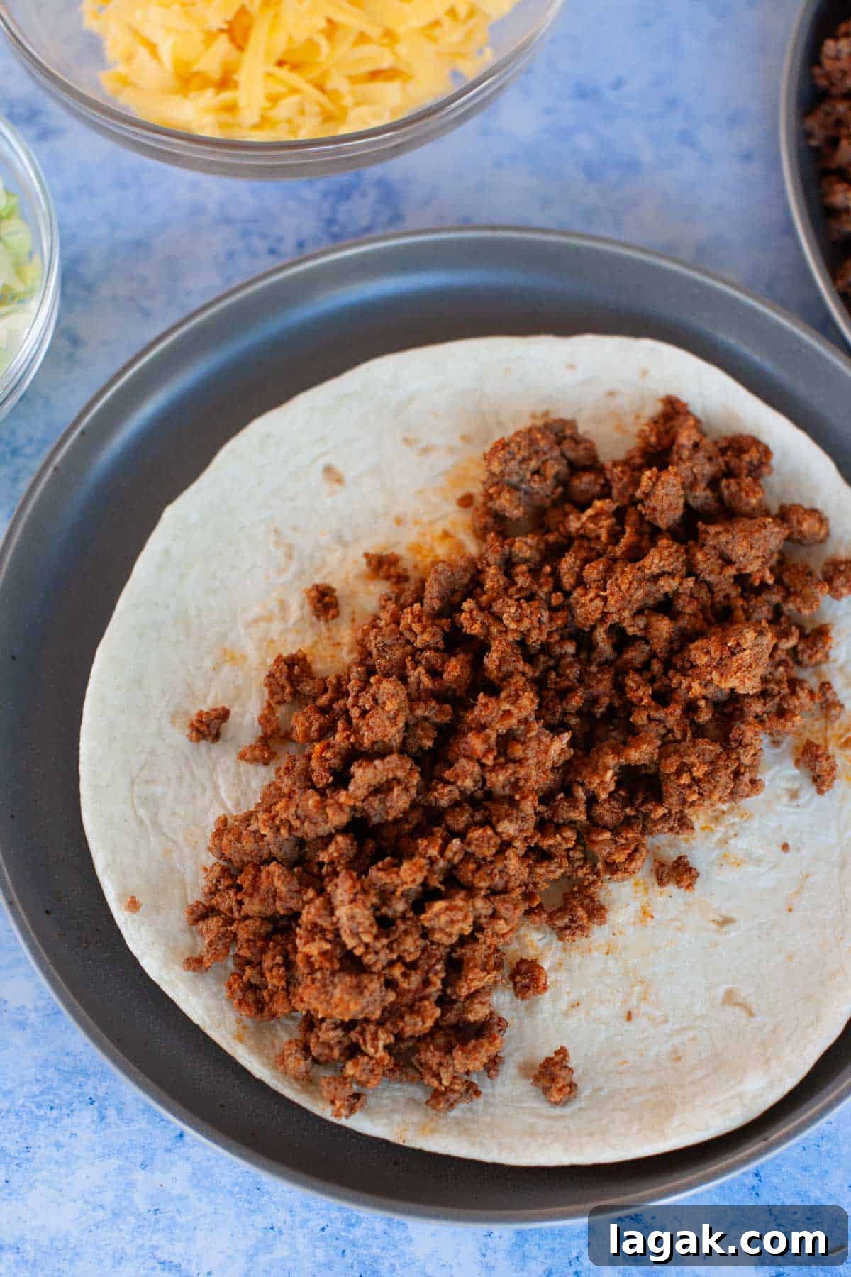 Authentic Ground Beef Tacos Recipe for Weeknight Dinners 7 A plate of ground beef tacos with meat and cheese on it.