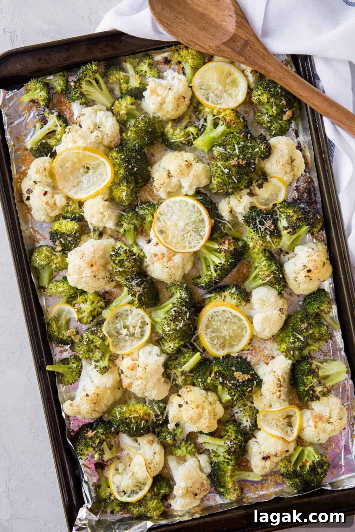 Crispy Roasted Broccoli & Cauliflower with Parmesan and Lemon 2 roasted broccoli and cauliflower on a sheet pan after roasting in the oven.