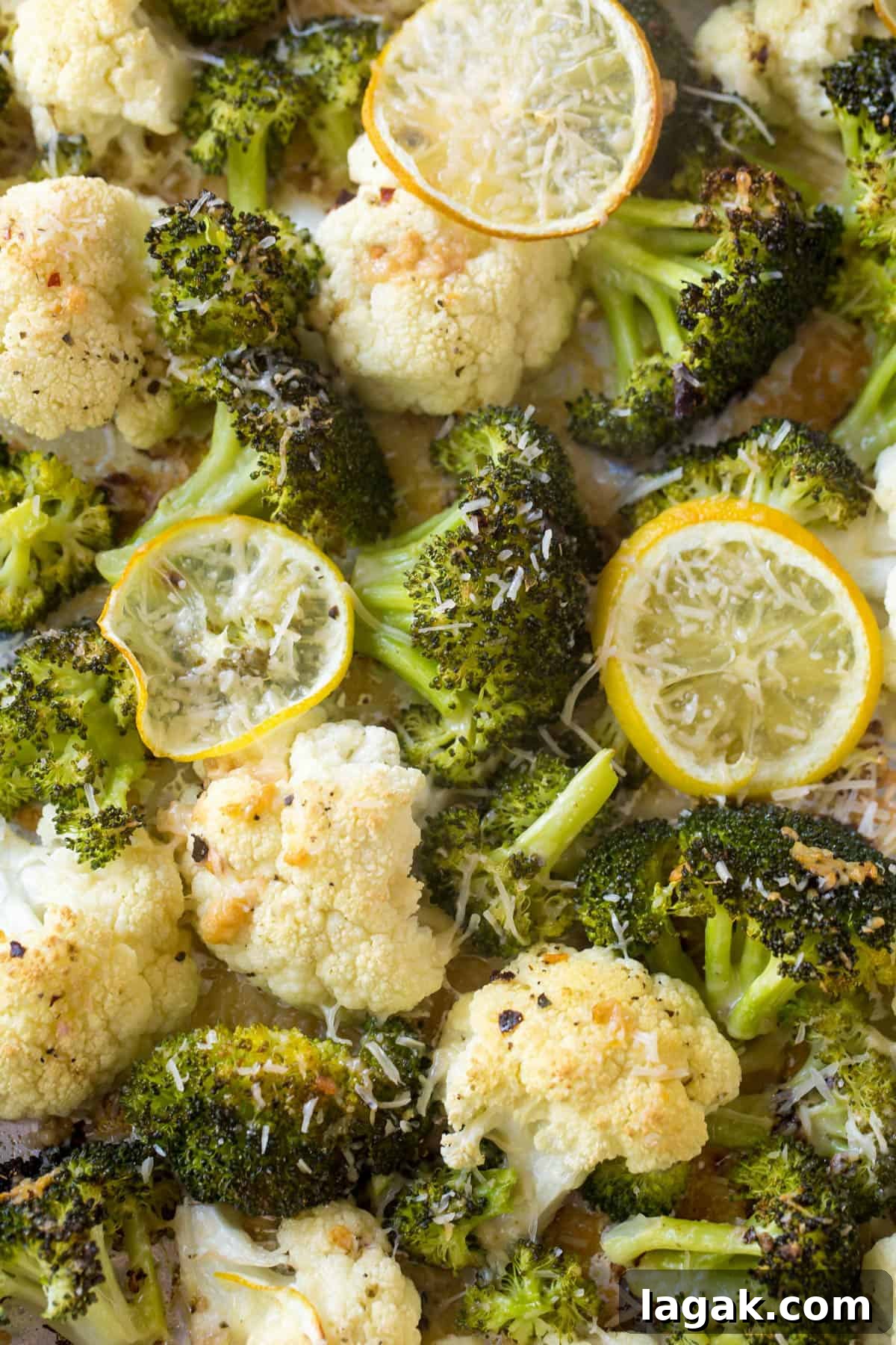Crispy Roasted Broccoli & Cauliflower with Parmesan and Lemon 4 Cooked broccoli and cauliflower with lemon slices on top.