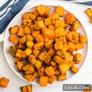 Crispy Air Fryer Sweet Potato Cubes Recipe 16 Overhead shot of air fryer sweet potato cubes on a white plate ready to serve.