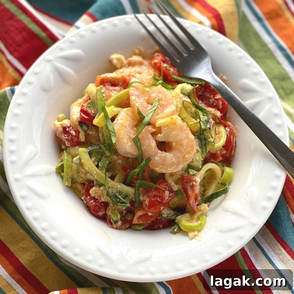 Shrimp and Zoodle Baked Feta Pasta with Garlic Lemon Sauce 2 Viral Tik Tok Baked Feta Zoodles and Shrimp in a bowl with a fork.