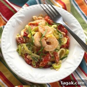 Shrimp and Zoodle Baked Feta Pasta with Garlic Lemon Sauce 9 Viral Tik Tok Baked Feta Zoodles and Shrimp in a bowl with a fork.