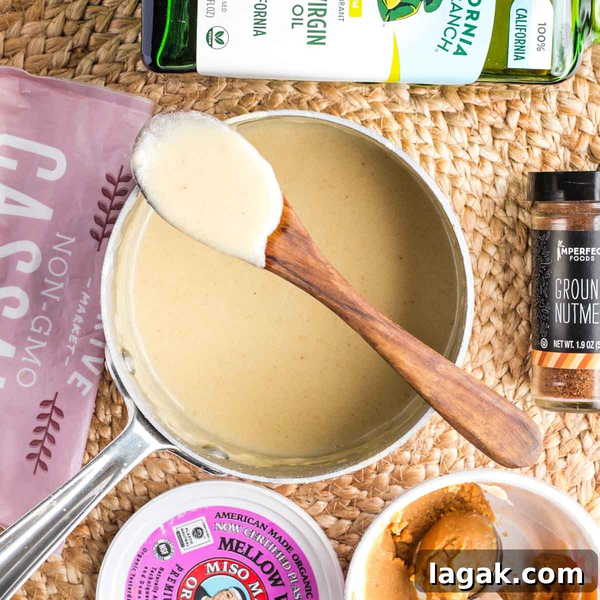 Pot of bechamel sauce with spoon.
