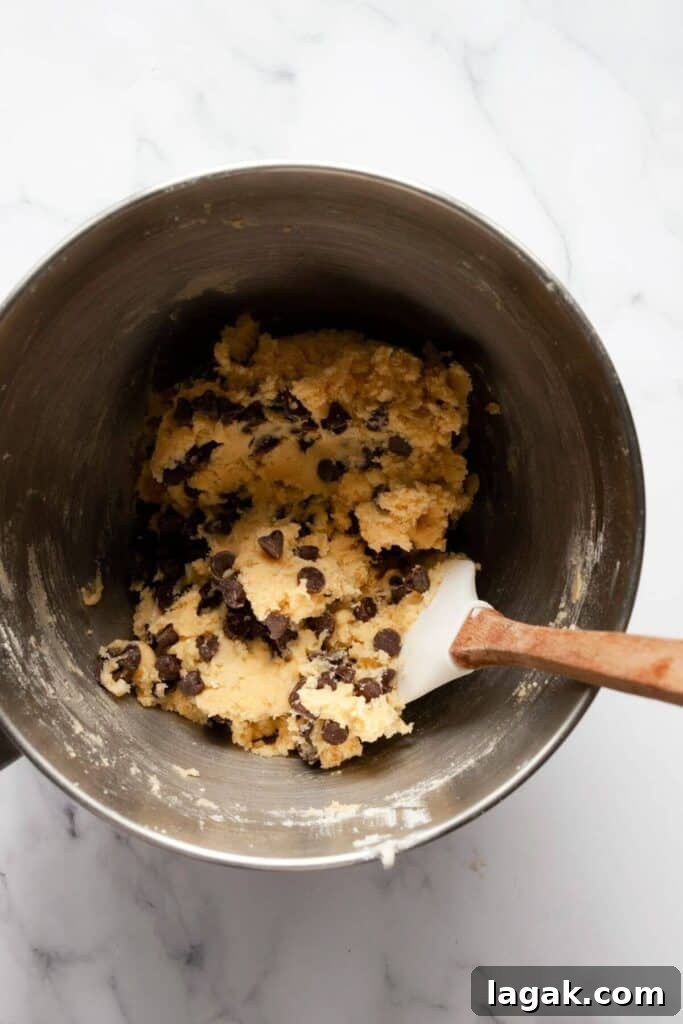 Classic Chocolate Chip Cookies Made Without Brown Sugar 8 hand mixing in chocolate chips to the cookie dough