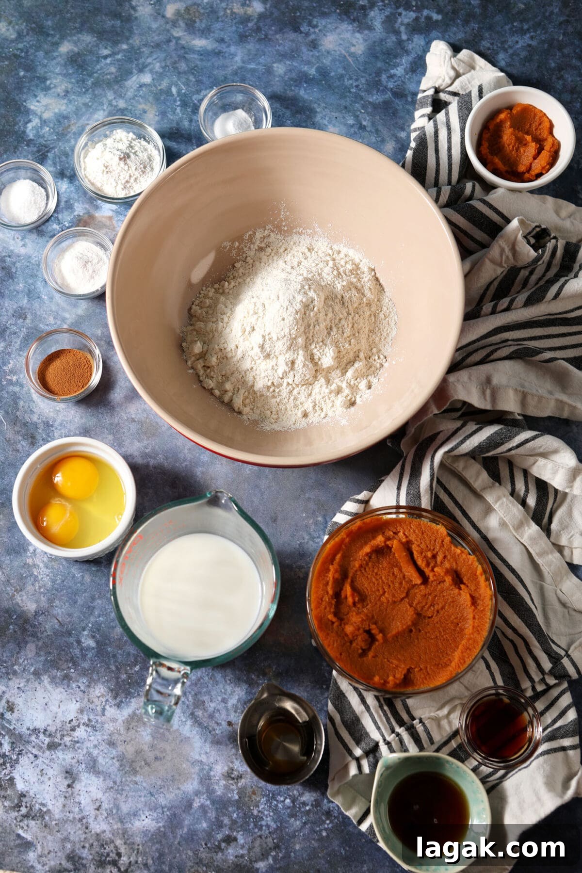 Pumpkin Waffles with Cinnamon Maple Syrup Recipe 3 Ingredients to make homemade waffles with pumpkin puree in bowls on a blue surface with white and black striped linens