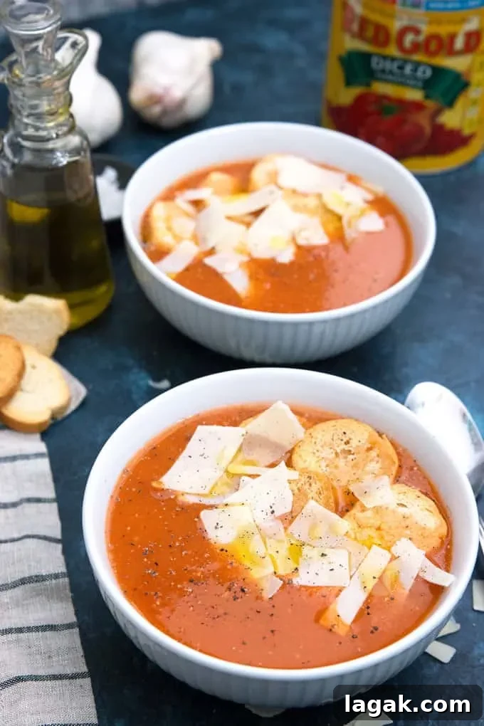 roasted garlic tomato soup garnished with croutons, parmesan cheese and olive oil