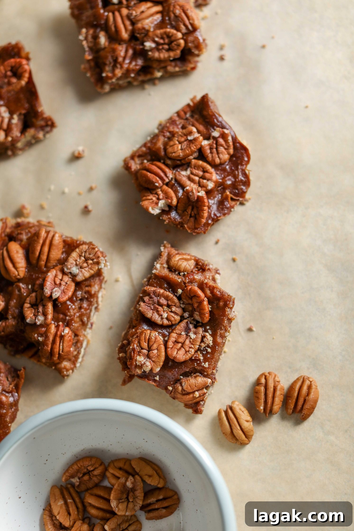 Chewy Pecan Pie Bars with Buttery Shortbread Crust 9 Vegan Pecan Pie Bars sliced on parchment paper by Flora & Vino