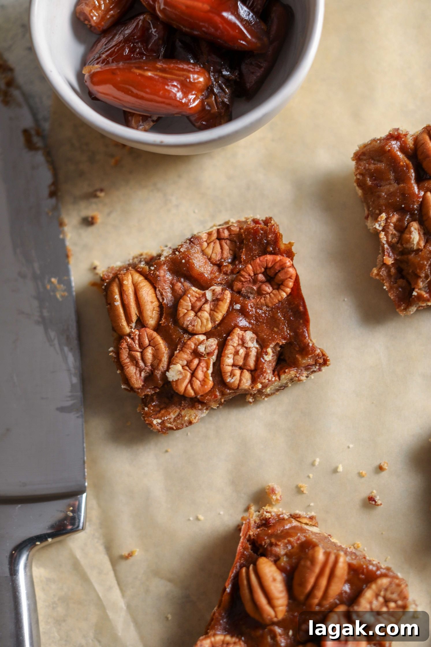 Chewy Pecan Pie Bars with Buttery Shortbread Crust 10 Vegan Pecan Pie Bars sliced on parchment paper by Flora & Vino