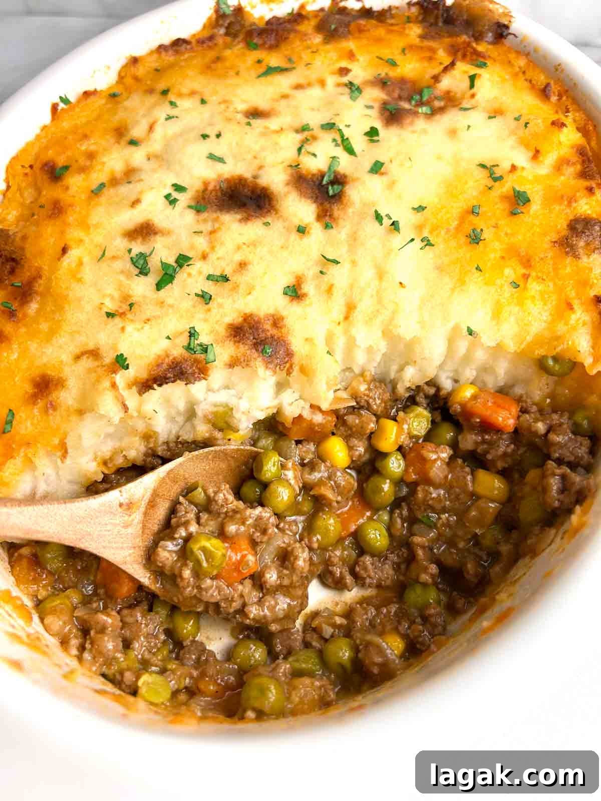 shepherd's pie with chunk taken out of it to show the meat filling.