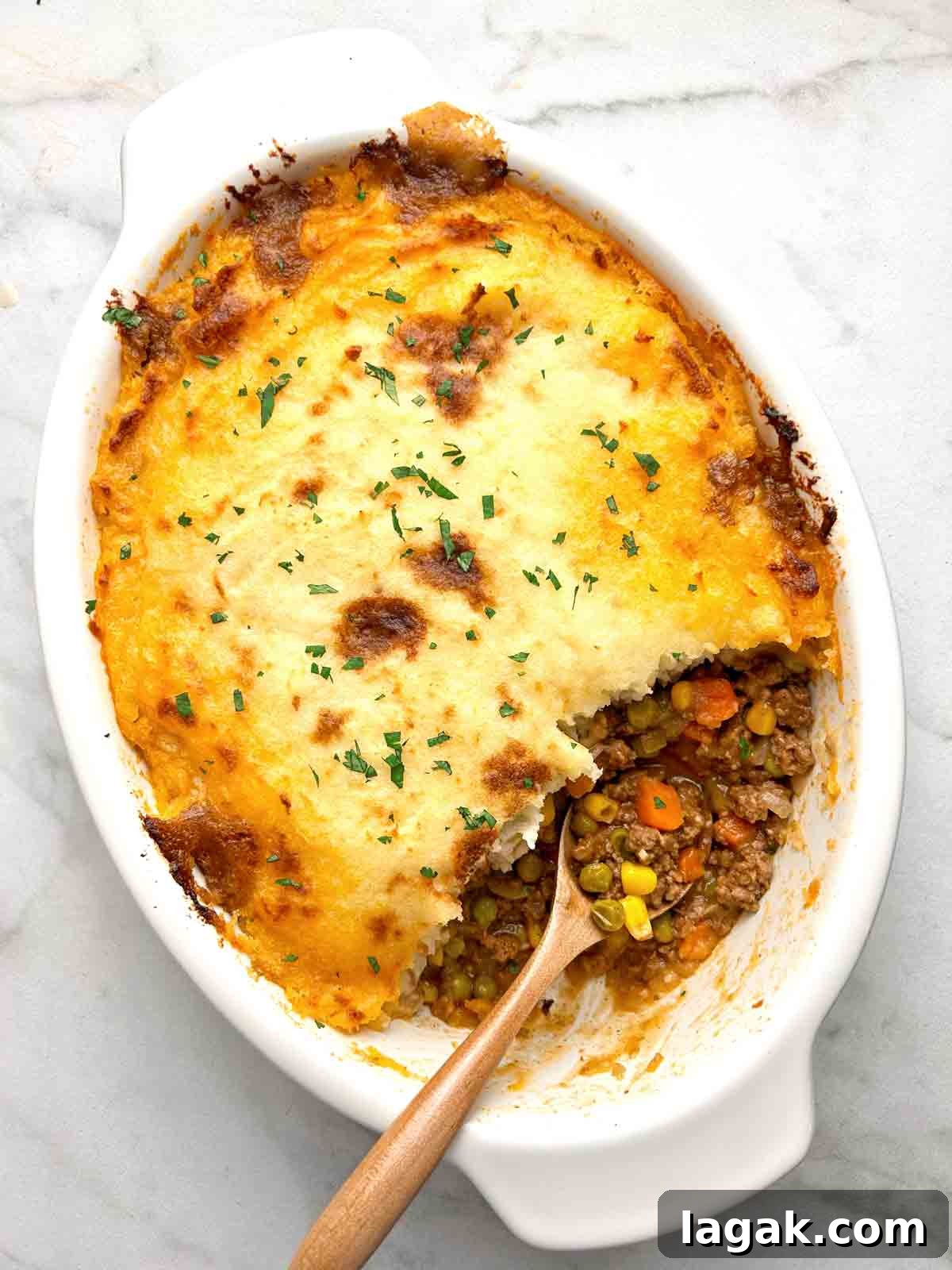 shepherd's pie with chunk taken out of it to show the meat filling.
