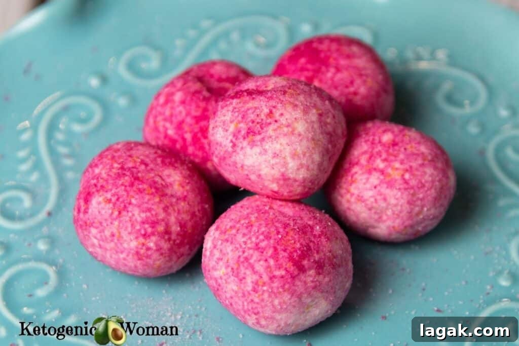 Pink Raspberry Jello Balls arranged on blue plate