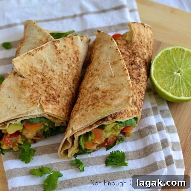 Creamy Shrimp and Avocado Wrap Recipe for Light Lunch 4 Shrimp Avocado Wraps placed on a tea towel with half a lime next to them