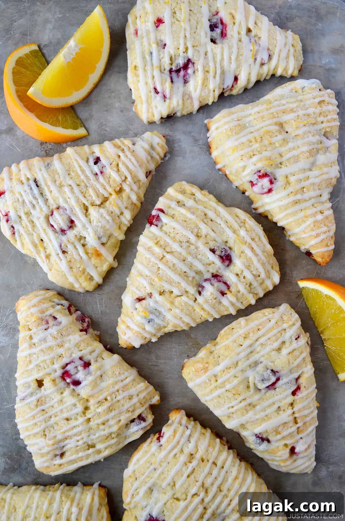 Cranberry Orange Scones with Sweet Citrus Glaze 2 Cranberry orange scones with a simple orange glaze on a marble surface.