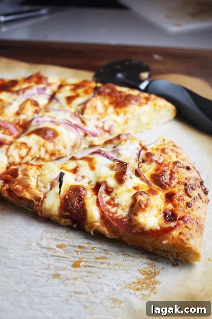 Buffalo Chicken Pizza Recipe: Spicy Homemade Pizza with Blue Cheese 2 Slice of Buffalo chicken pizza on parchment paper