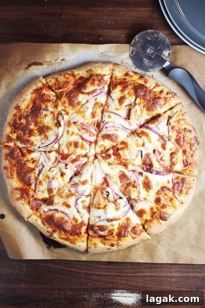 Buffalo Chicken Pizza Recipe: Spicy Homemade Pizza with Blue Cheese 3 A whole round pizza, sliced, on parchment paper
