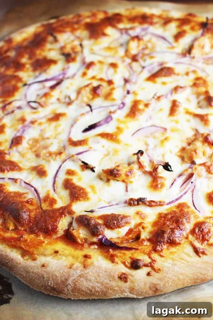 Buffalo Chicken Pizza Recipe: Spicy Homemade Pizza with Blue Cheese 4 Closeup of an unsliced Buffalo Chicken Pizza