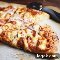 Slice of Buffalo chicken pizza on parchment paper