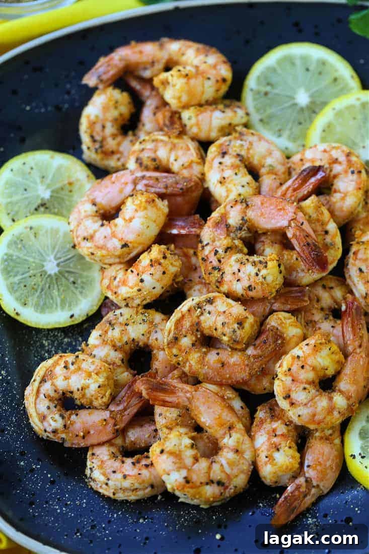 Lemon Pepper Shrimp made in an air fryer on a black plate