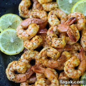 Lemon Pepper Shrimp made in an air fryer on a black plate