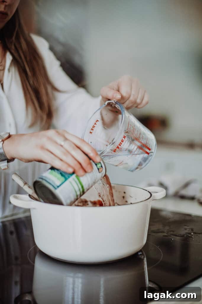 adding water into a cast-iron pot