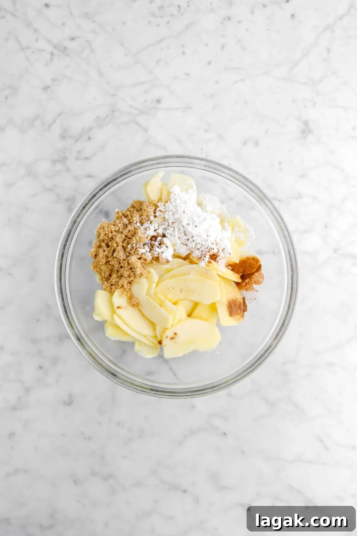 Caramel Apple Galette Recipe: Rustic Fall Dessert with Salty Caramel 14 apple slices, brown sugar, cornstarch, and spices in glass bowl