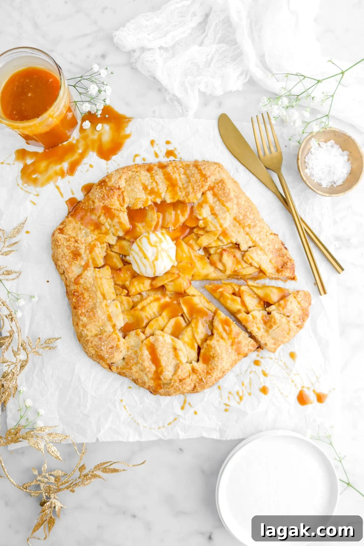 Caramel Apple Galette Recipe: Rustic Fall Dessert with Salty Caramel 22 slice cut from galette on parchment paper with fork and knife beside