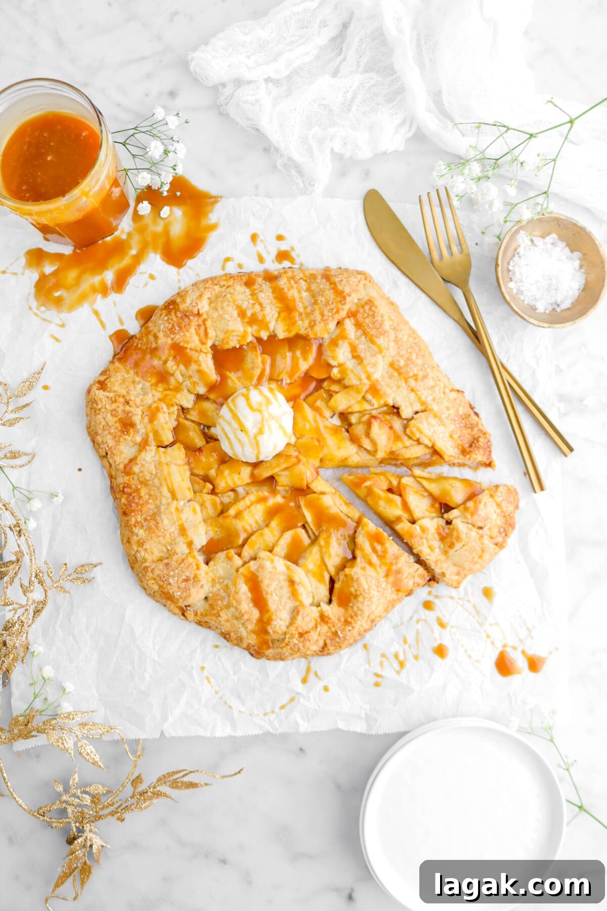 Caramel Apple Galette Recipe: Rustic Fall Dessert with Salty Caramel 6 slice cut from galette on parchment paper with fork and knife beside