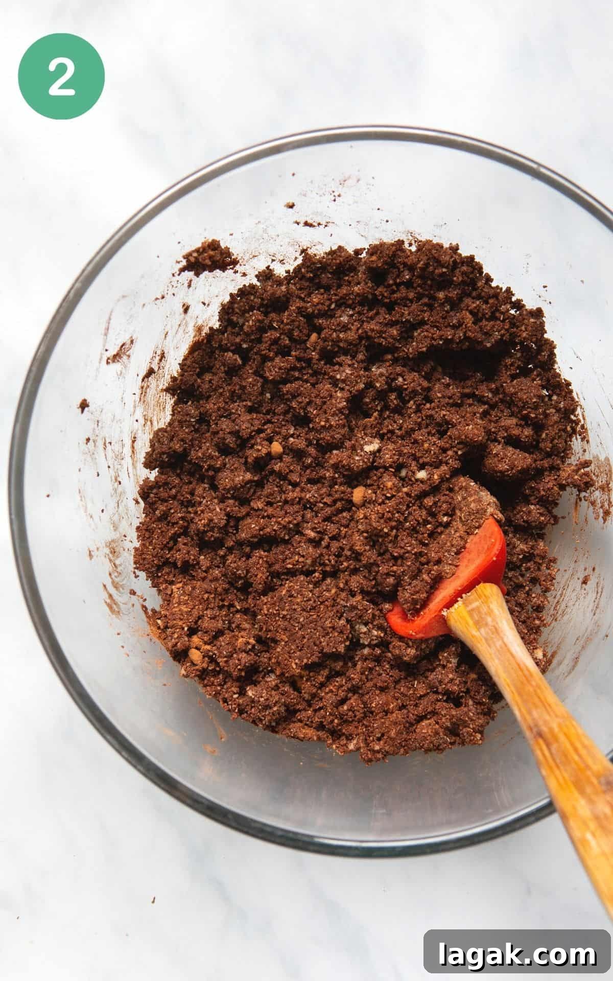Decadent Vegan Chocolate Tart Recipe for Rich, Creamy Desserts 5 Instructional photo of a bowl having the ingredients for the crust mixed together in a glass bowl.