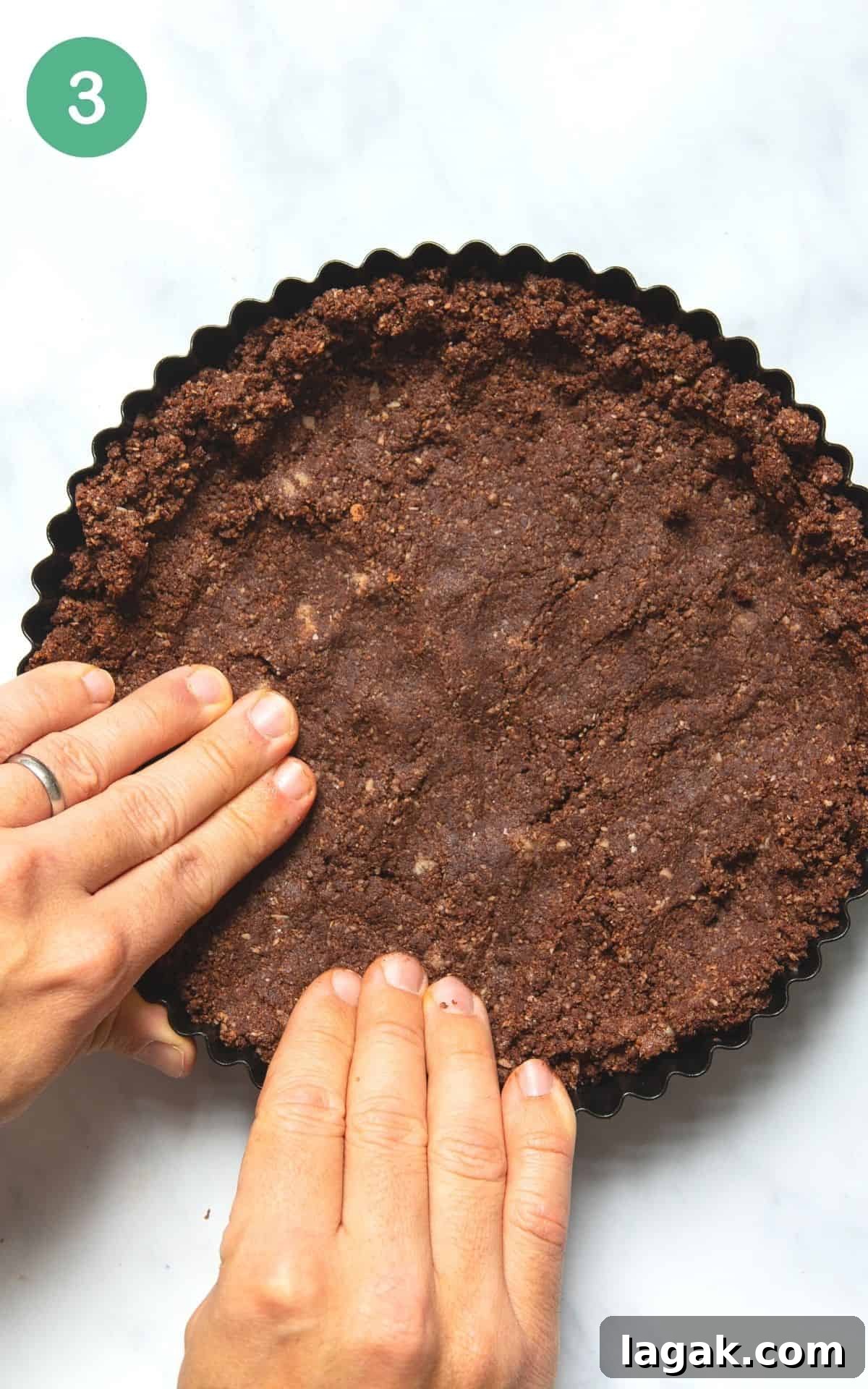 Decadent Vegan Chocolate Tart Recipe for Rich, Creamy Desserts 6 Instructional photo showing the tart crust being pressed into a tart tin.