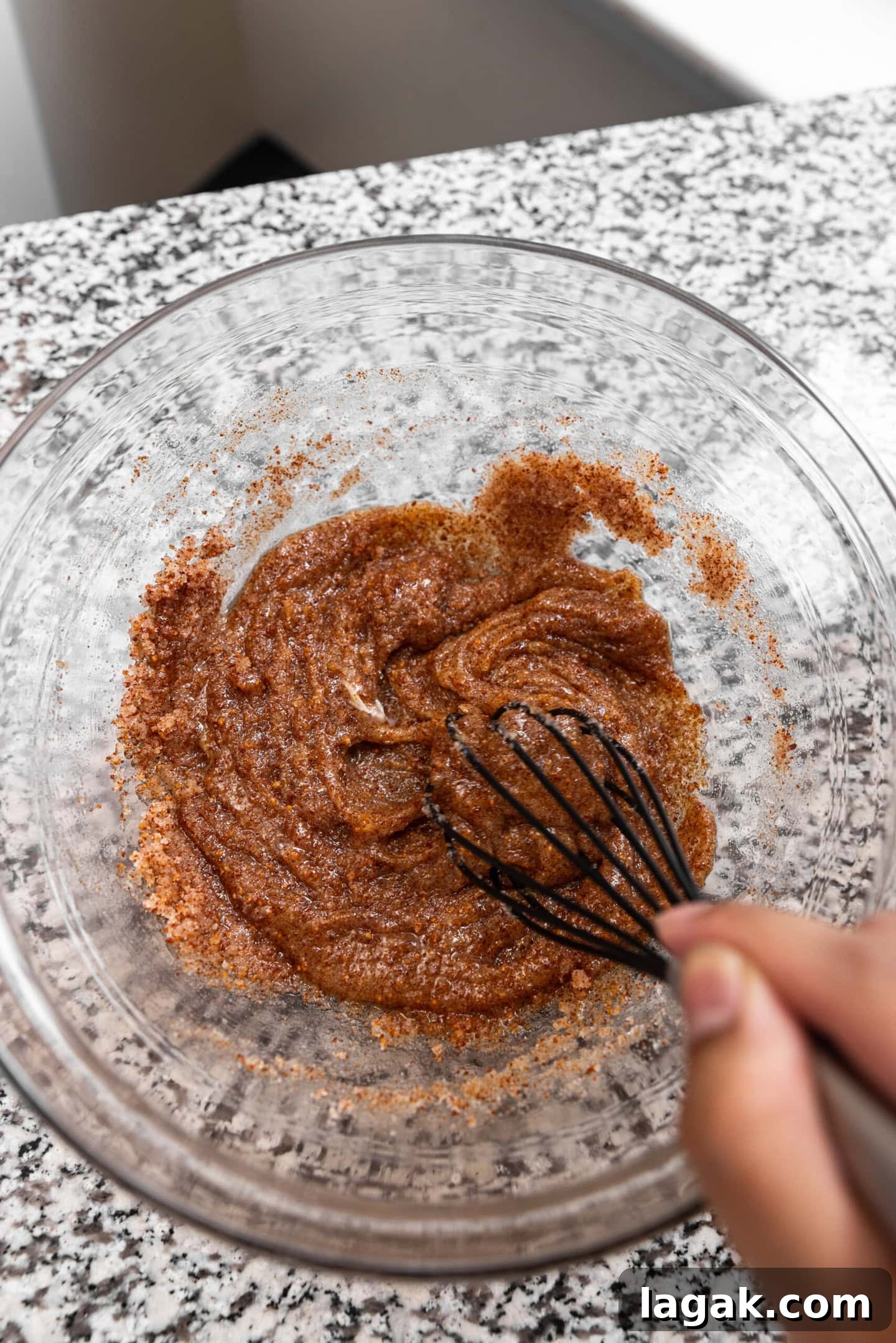 Egg and vanilla being whisked into the butter and sugar mixture.