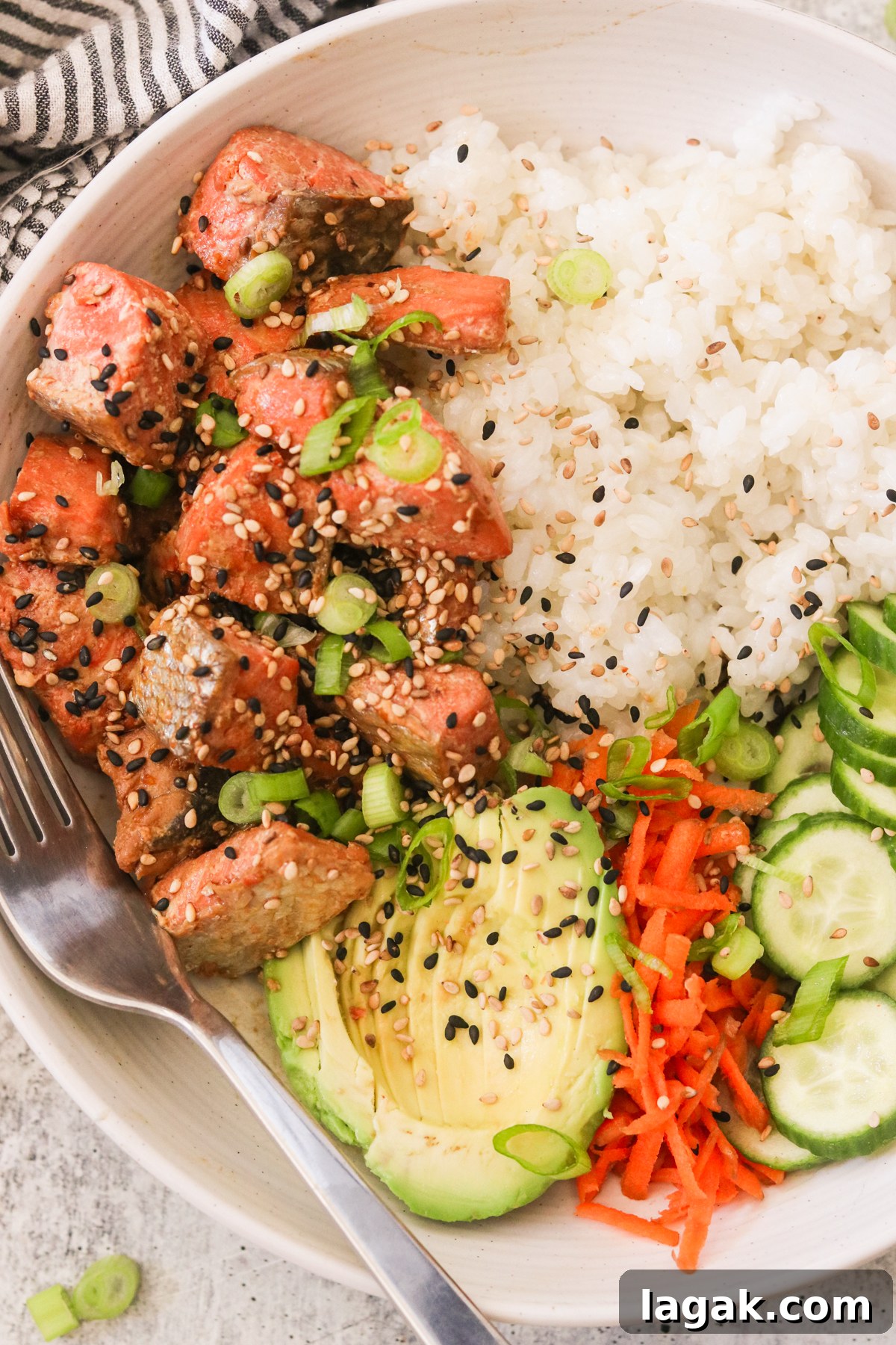 Crispy Air Fryer Teriyaki Salmon Recipe in 20 Minutes 2 air fryer teriyaki salmon in a bowl of recipe topped with sesame seeds and green onions