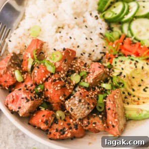 Crispy Air Fryer Teriyaki Salmon Recipe in 20 Minutes 7 air fryer teriyaki salmon in a bowl of recipe topped with sesame seeds and green onions