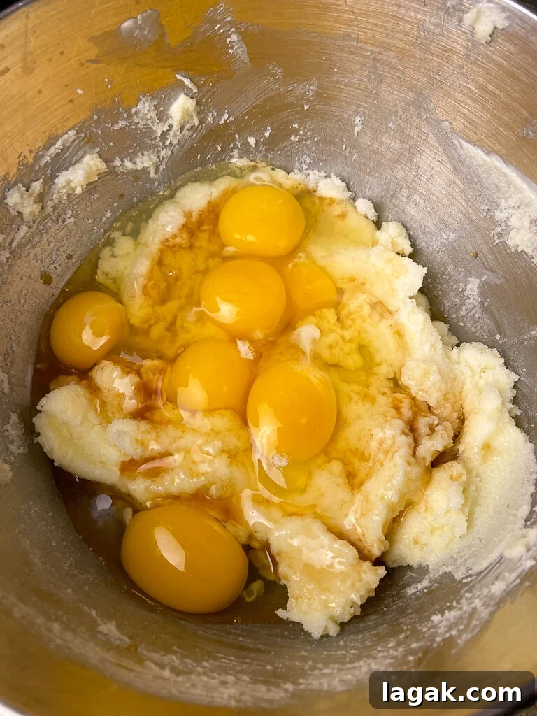 Eggs on top of a sugar and butter base for a big batch of brownies